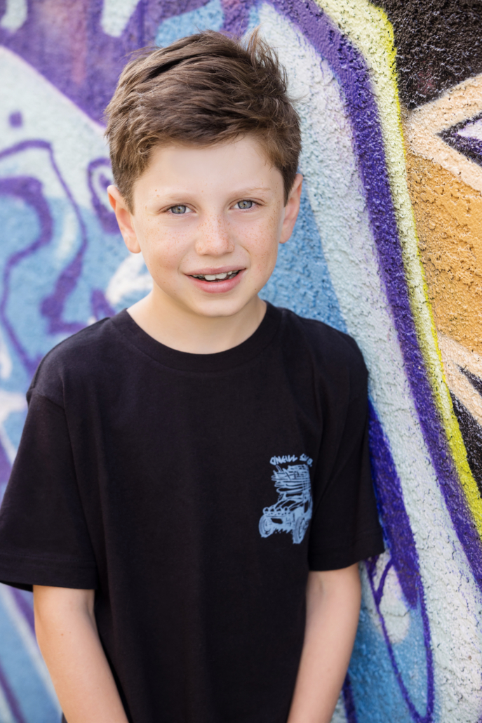 Individual portrait of an 8 year old boy in Santa Ana art district amongst the graffiti walls.