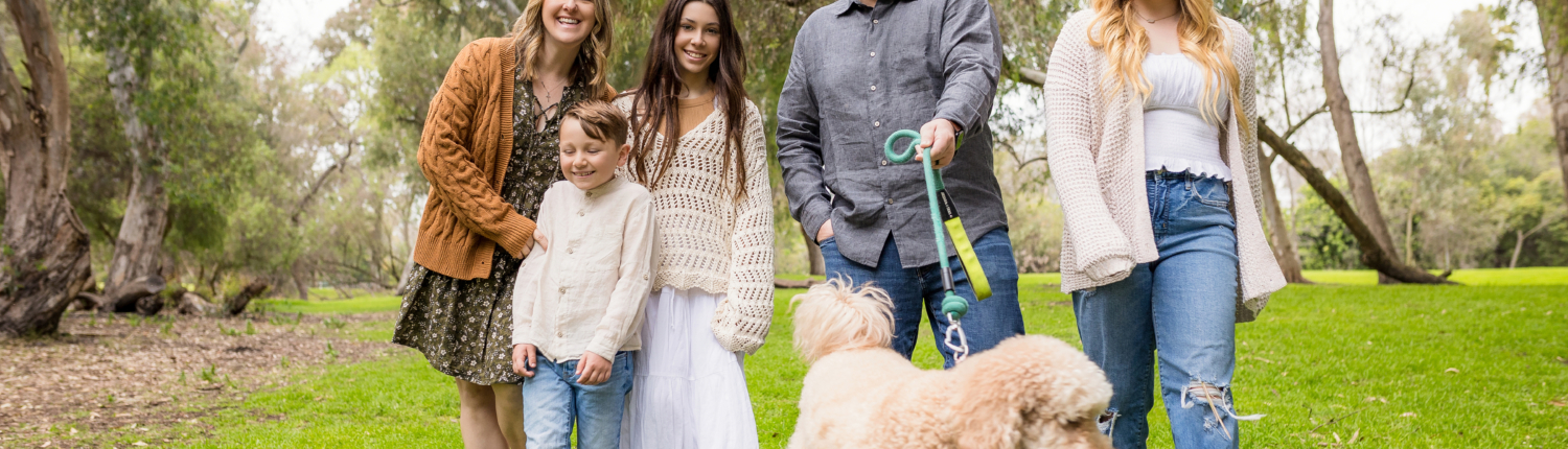 Family candid photo walking the dog at Huntington Beach Central Park wearing Fall colors