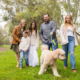 Family candid photo walking the dog at Huntington Beach Central Park wearing Fall colors